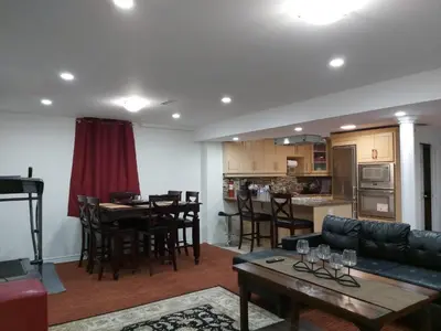 a living room and kitchen with a couch and a table at Guest House Room No 02 in Mississauga