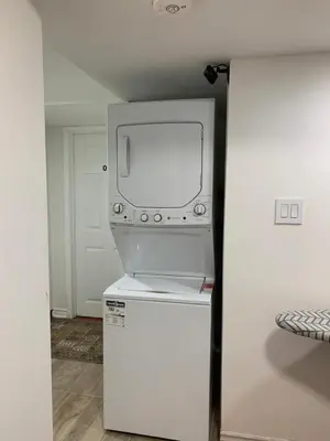 a tv sitting on top of a refrigerator in a room at Guest House Room No 02 in Mississauga