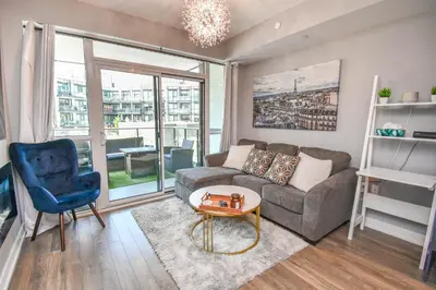 a living room with a couch and a chair at PET FRIENDLY CONDOS at FRIDAY HARBOUR in Innisfil