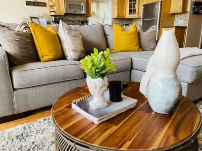 a living room with a couch and a table with vases at SouthLake Cottage on The Lake. in Washago