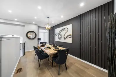 a dining room with a wooden table and chairs at Modern 4 Level home-Game room/Parking/Near Airport in Mississauga