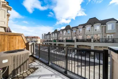 a balcony with a fence and some buildings at Modern 4 Level home-Game room/Parking/Near Airport in Mississauga