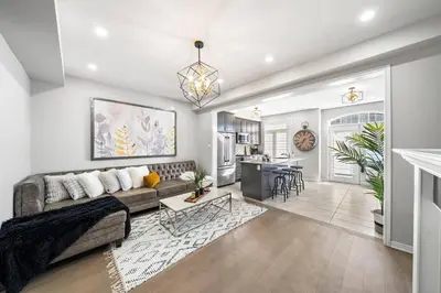 a living room with a couch and a table at Modern 4 Level home-Game room/Parking/Near Airport in Mississauga