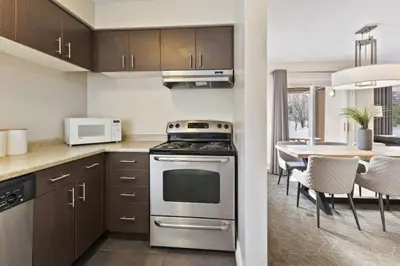 a kitchen with a stove and a dining room at Blue Mountain Chalet Condo with Amazing Location in Blue Mountains