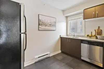 a kitchen with a refrigerator and a sink at Blue Mountain Chalet Condo with Amazing Location in Blue Mountains
