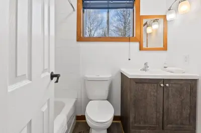 a bathroom with a toilet and a sink and a tub at Large Chalet for up to 16 ppl close to mountains in Blue Mountains