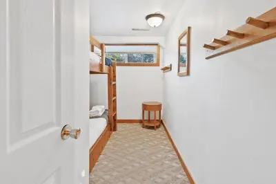a room with a door leading to a bunk room at Large Chalet for up to 16 ppl close to mountains in Blue Mountains