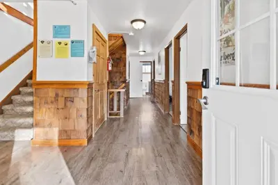 a hallway of a house with wooden floors and a staircase at Large Chalet for up to 16 ppl close to mountains in Blue Mountains
