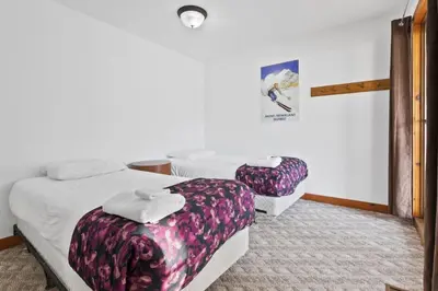 a room with two beds and a wall at Large Chalet for up to 16 ppl close to mountains in Blue Mountains