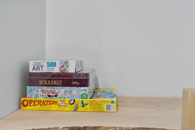 a stack of books sitting on a shelf at Four Peaks - Unit 40A in Collingwood