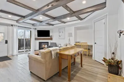 a living room with a couch and a table at Four Peaks - Unit 40A in Collingwood