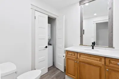 a bathroom with a sink and a toilet and a mirror at Four Peaks - Unit 40A in Collingwood