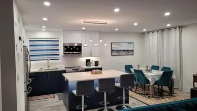 a kitchen and dining room with a table and chairs at Mama Gol in Richmond Hill