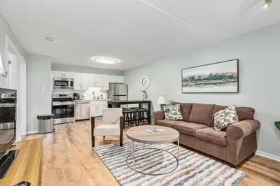 a living room with a couch and a table at The Nordic - Central Collingwood Condo in Collingwood
