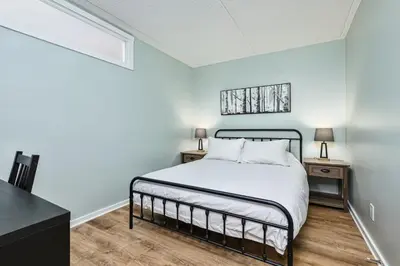 a bedroom with a bed and two night stands at The Nordic - Central Collingwood Condo in Collingwood