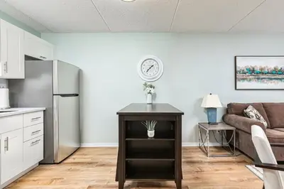 a living room with a couch and a table at The Nordic - Central Collingwood Condo in Collingwood