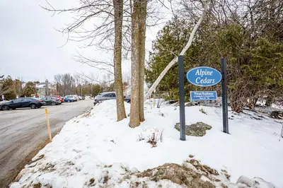 a blue clinic sign in the snow next to a street at The Nordic - Central Collingwood Condo in Collingwood