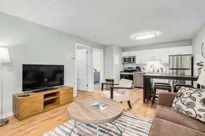 a living room with a couch and a table at The Nordic - Central Collingwood Condo in Collingwood