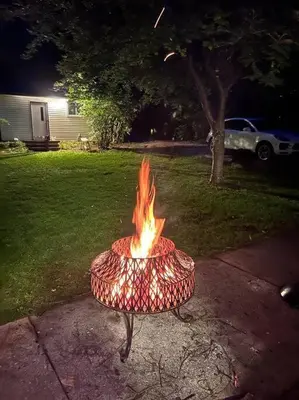 a fire in a pot on a sidewalk at Marmora Hideaway - Lake front in Marmora