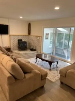 a living room with a couch and a coffee table at Marmora Hideaway - Lake front in Marmora