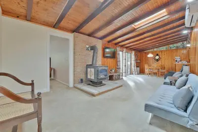 a living room with a fireplace in a house at Rustic cottage on Canal Lake in Carden