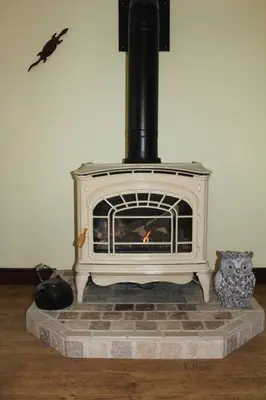 a white fireplace with a bird flying above it at Rustic Pines Waterfront Cottage *CLEAR WATER* in Fenelon Falls