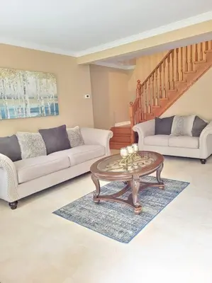 a living room with two couches and a coffee table at Whispering Pines Riverside Retreat in Coboconk
