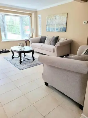 a living room with two couches and a coffee table at Whispering Pines Riverside Retreat in Coboconk