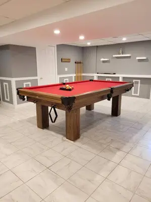 a pool table in a room with a red top at Whispering Pines Riverside Retreat in Coboconk