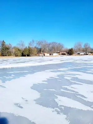 a frozen lake with snow on top of it at Chemong Lake Waterfront Cottage☆privateboatlaunch in Lakefield