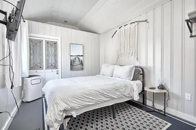 a white bedroom with a bed and a window at Muskoka Honey Harbour 4-Bed Retreat with Hot Tub in Honey Harbor
