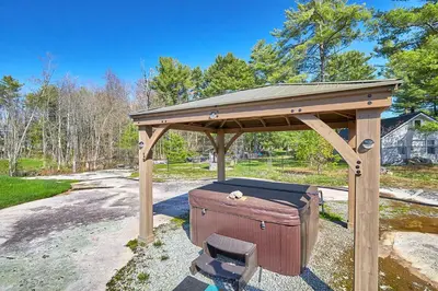 a wooden gazebo with a suitcase under it at Muskoka Honey Harbour 4-Bed Retreat with Hot Tub in Honey Harbor