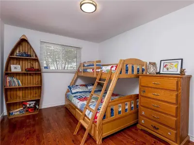 a bedroom with a bunk bed and a ladder at Cozy Escape, Kawarthas Cottage With Sauna in Buckhorn