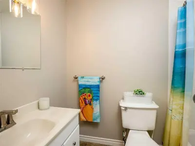 a bathroom with a white toilet and a sink at Cozy Escape, Kawarthas Cottage With Sauna in Buckhorn