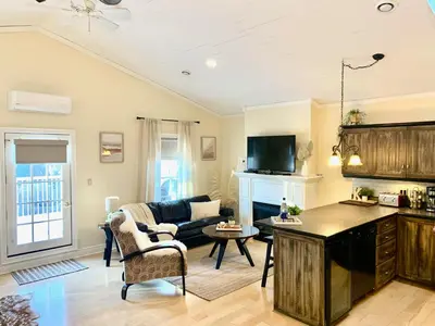 a living room with a couch and a table at Suites On King in Niagara on the Lake