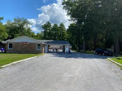 a car parked in front of a building at Three Island Motel in Bobcaygeon
