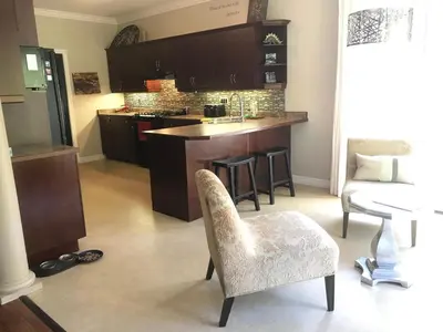 a kitchen with a table and chairs and a counter at Cozy Luxury on the Thames in Ontario! in London