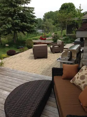 a patio with couches and a table and chairs at Cozy Luxury on the Thames in Ontario! in London