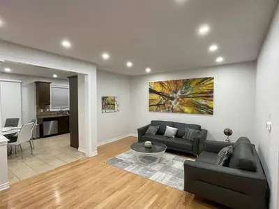 a living room with a couch and a table at Luxury 4-Bedrooms Home… in Brampton
