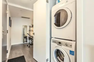 a laundry room with a washer and dryer at Traveller home in centre Toronto in Toronto