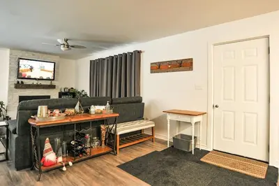 a living room with a couch and a table at Modern Rustic Home with Wood Stove & Pool Table in Kemble