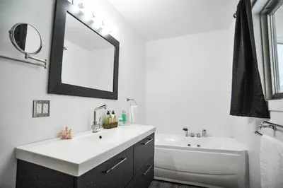 a bathroom with a sink and a tub and a mirror at Modern Rustic Home with Wood Stove & Pool Table in Kemble