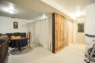 a living room with a table and a couch at Modern Rustic Home with Wood Stove & Pool Table in Kemble