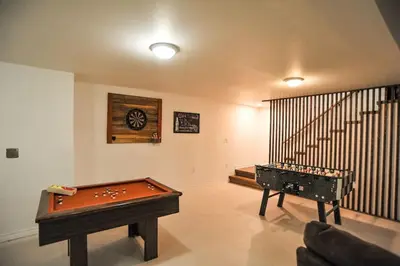 a room with a pool table and a staircase at Modern Rustic Home with Wood Stove & Pool Table in Kemble