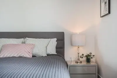 a bedroom with a bed and a lamp on a nightstand at Luxury Condo on Bay Street in Toronto