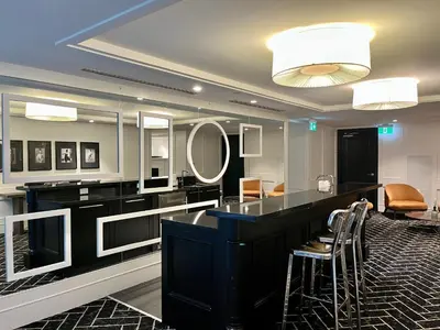 a room with a bar with chairs and a mirror at Luxury Condo on Bay Street in Toronto