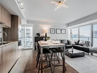 a kitchen and living room with a table and a couch at Luxury Condo on Bay Street in Toronto