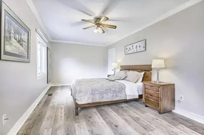 a bedroom with a bed and a ceiling fan at 5 Bedroom Vacation Cottage - King City in Schomberg