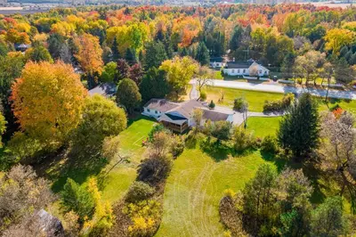 an aerial view of a house on a field with trees at 5 Bedroom Vacation Cottage - King City in Schomberg