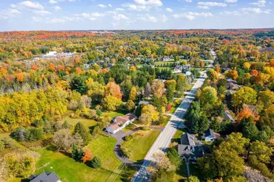 an aerial view of a town with fall trees at 5 Bedroom Vacation Cottage - King City in Schomberg